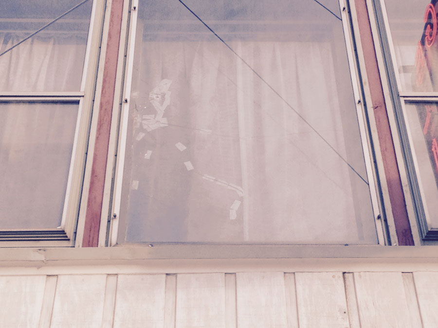 Bullet hole in the window above the Habibi Sheesha Lounge