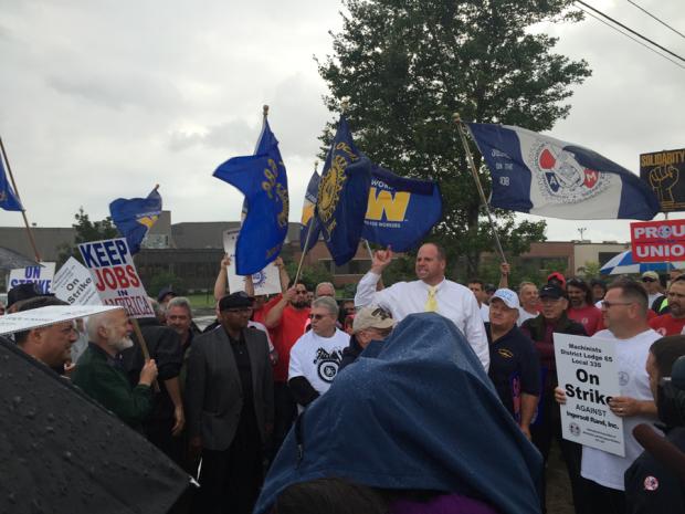 State Senator&nbsp;Tim Kennedy addresses the crowd in the rain.
