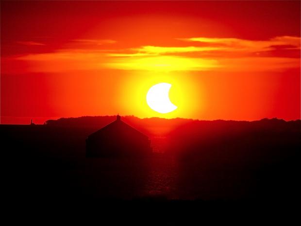 Dancing till the end of time as new reports reveal the end game of&nbsp;the Sixth Extinction. Photo of a solar eclipse over Fort Erie from Buffalo's Inner Harbor. (photo by Jay Burney)
