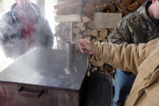 Fred Thurnherr testing sugar content of boiling sap. Photo by Nancy J. Parisi.
