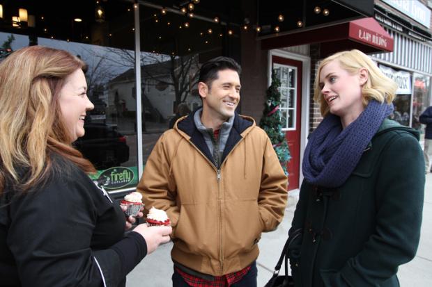 Firefly Cupcakes owner Wendy Egloff has a cameo with David O’Donnell and Abigail Hawk on Main Street in East Aurora. Photos courtesy of the&nbsp;Buffalo Niagara Film Office.
