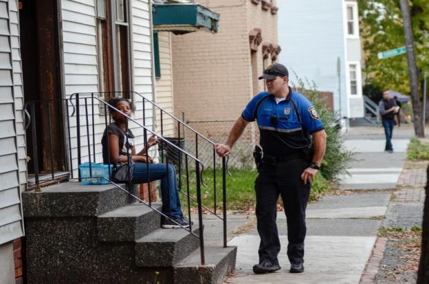 Albany Police Officer Justin&nbsp;Wallace talks with an Albany resident as part of his duty on the city's neighborhood engagement unit. (Heather Ainsworth)
