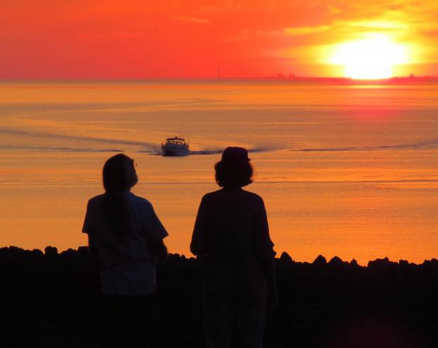 Citizens watch the sunset over the Great Lakes. Photo by Jburney
