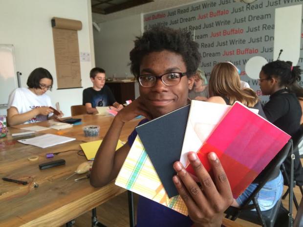 That is JBWC Youth Ambassador, Ikuris, at the JBWC during a chapbook-making workshop taught by Joel Brenden.
