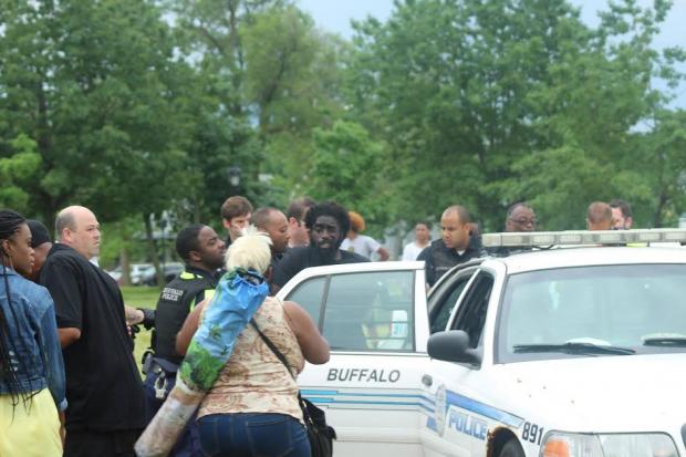 Matthew Boaz Singletary, after being pepper-sprayed by police at Juneteenth last weekend, is escorted into a squad car.
