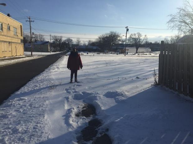 Marva Threat on Detroit Street, where her property line ends and the uncleared, city-owned sidewalk begins.&nbsp;
